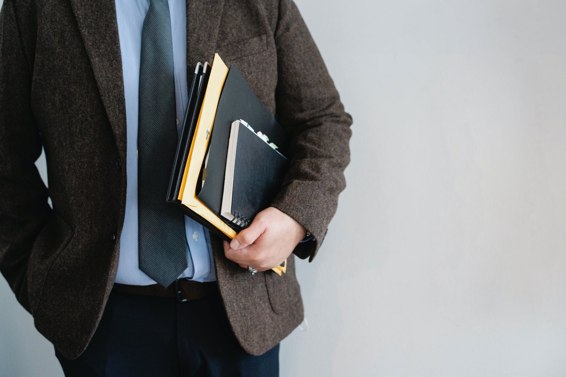 crop unrecognizable office worker standing with papers in hand