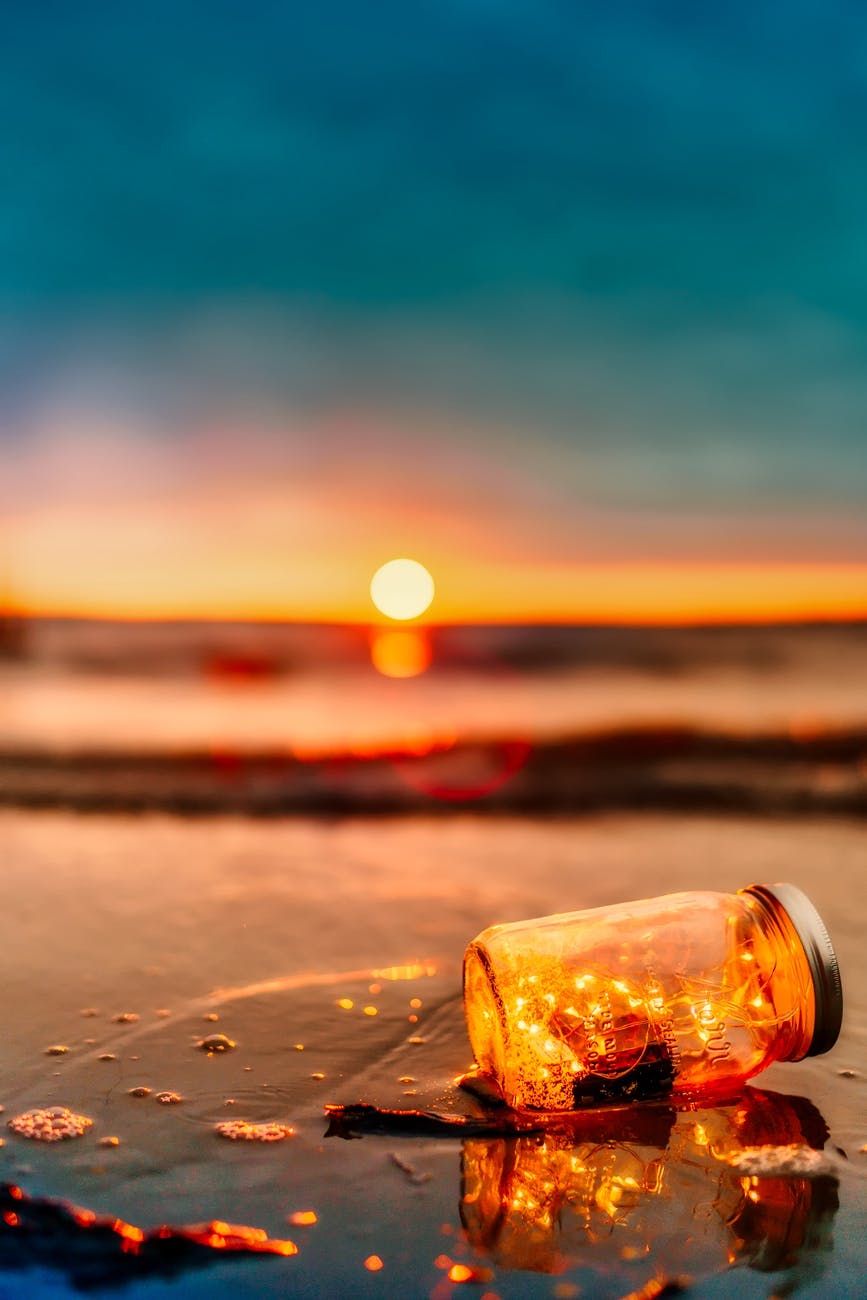 orange mason jar in body of water